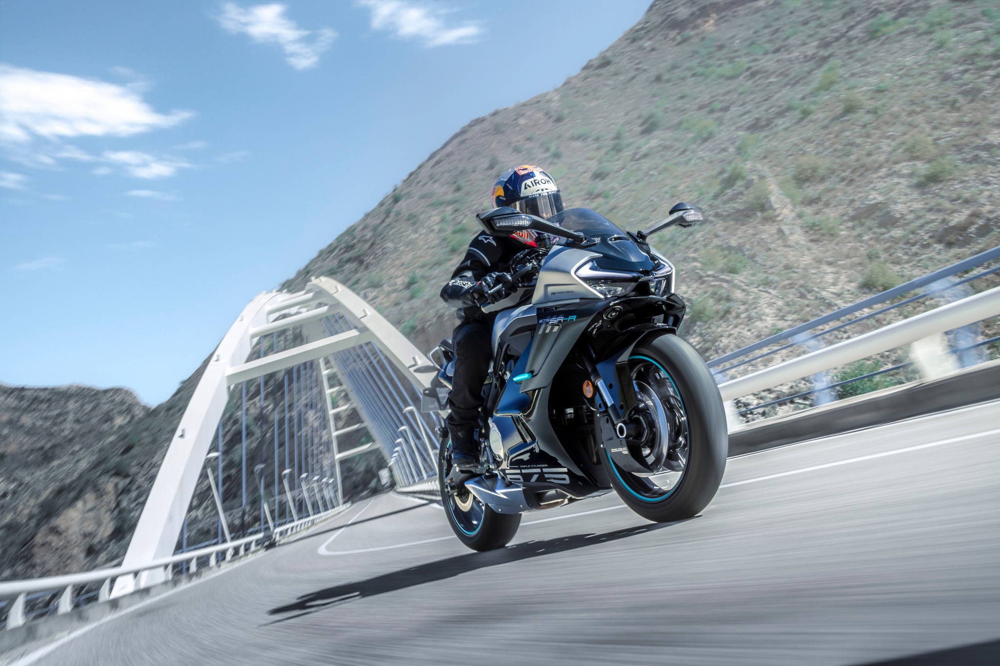 CFMOTO 675SR-R and rider on a mountain road